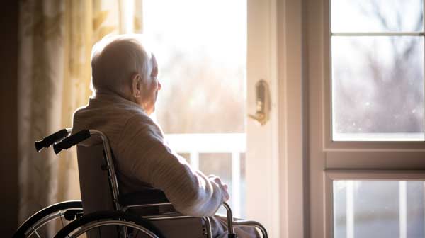 Opa geniesst zuhause im Rollstuhl den Ausblick